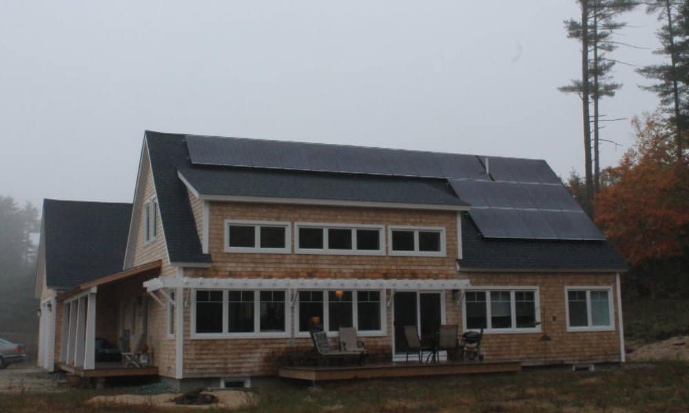Brightbuilt Home Little Diamond prefab home exterior view showing rear deck and roof mounted solar panels.